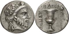 The Prospero Collection of Ancient Greek Coins. AEGEAN ISLANDS. The Cyclades, Naxos (c.250-220 B.C.), Silver Didrachm, 7.12g,. Magistrate Xenod... Bearded head of Dionysos facing to right, wearing an 