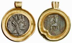 ANCIENT COINAGE ANCIENT COINS AS MODERN JEWELLERY No.: 5675 Schätzwert/Estimate: CHF 800.- Tetradrachm of Laodiceia set in massive gold frame with loop. 54,12 g. (approx. 37 g. gold). Extremely fine.