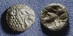 Asia Minor, Uncertain city Circa 450 BC, Tetartemorion, .12g: Obv: Roaring lion head right Rev: Incuse punch. Ref CNG 269/136.