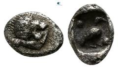 Greek Ionia. Miletos circa 525-500 BC. Tetartemorion AR 5mm., 0,21g. Forepart of lion left, head looking backwards, with open jaws and tongue protruding / Bird standing right between two pellets diago