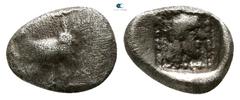 Greek Dynasts of Lycia. Uvug 470-440 BC. Hemiobol AR 7mm., 0,37g. Forepart of winged man-headed bull right / Laureate head of Apollo right within dotted square border; all within incuse square. nearly