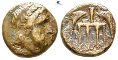 Greek Islands of Thessaly. Ikos circa 300-200 BC. Dichalkon Æ 17 mm., 3,99 g. Bearded and wreathed head of Poseidon right / I-K-I-Ω-N, four-pronged trident downwards, with dolphins on either side swim
