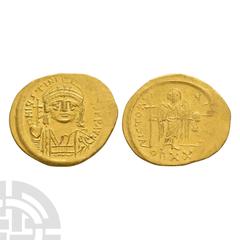 Coins - Byzantine Justinian I - Light Gold Solidus 527-565 A.D. Ravenna mint. Obv: D N IVSTINIANVS P P AVG legend with helmetted and cuirassed bust facing holding globus cruciger and shield. Rev: VICT