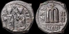 Byzantine BYZANTINE EMPIRE. Phocas. 602-610. Æ follis. 10 gm. 28 mm. Theoupolis (Antioch) Mint. Phocas and Leontia standing facing; Phocas holding globus cruciger, Leontia holding cruciform scepter / 