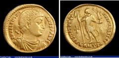 Ancient Coins Au solidus. Valentinian I. C, 364-75 AD. Antioch. Rev; RESTITVTOR REIPVBLICAE; Valentinian standing facing, holding labarum and Victory, ANTI in ex. RIC 1a. Marks on edge, graffiti. G Fi
