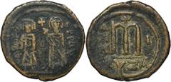 ANCIENT COINS Byzantine Empire, Phocas, FollisByzantine EmpirePhocas (602-610), Follis 602-603, Cyzicus mintObverse: Phocas on the left, holding cross on globe, and Leontia, holding cross-surmounted s
