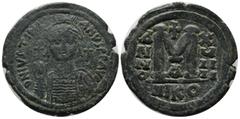 Byzantine Coins Justinian I. AD.527-565. Æ Follis (35mm, 20.14g). Nicomedia. D N IVSTINIANVS P P AVC. Helmeted, draped and cuirassed bust facing, holding globus cruciger and shield; cross in right fie