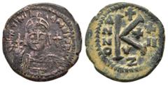 Byzantine Coins JUSTINIAN I.(527-565).Cyzicus.Half Follis. Obv : D N IVSTINIANVS P P AVC. Helmeted and cuirassed bust of Justinian I facing, holding globus cruciger in his right hand and shield over h