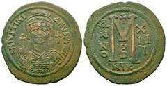Byzantine Coins JUSTINIAN I.527-565 AD.Nicomedia Mint.AE Follis Obverse : D N IVSTINIANVS P P AVG; Helmeted and cuirassed bust facing, holding globus cruciger and shield decorated with horseman motif 