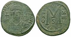 Byzantine Coins JUSTINIAN I.527-565 AD.Carthage Mint. AE Follis Obverse : D N IVSTINIANVS P P AVG; Helmeted and cuirassed bust facing, holding globus cruciger and shield decorated with horseman motif;