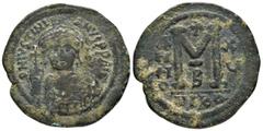 Byzantine Coins JUSTINIAN I.(527-565).Nicomedia.Follis. Obv : DN IVSTINIANVS PP AVG. Helmeted, cuirassed bust facing, holding cross on globe and shield with horseman motif, cross to right. Rev : Large