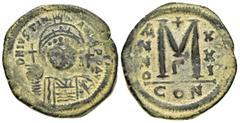 Byzantine Coins JUSTINIAN I.(527-565).Constantinople.Follis. Obv : D N IVSTINIANVS P P AVC. Helmeted, cuirassed bust facing, holding cross on globe and shield with horseman motif, cross to right. Rev 
