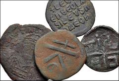 BYZANTINE. Lot of four (4) Æ Folles from Anastasius to the Anonymous series. Includes: Anastasius. Æ Half Follis // Justinian I. Æ Follis // Leo VI the Wise. Æ Follis // Anonymous. Æ Follis. Average F