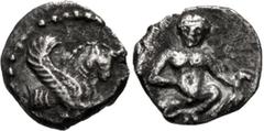 Greek SAMARIA, "Middle Levantine" Series. Circa 375-333 BC. AR Tetartemorion (6mm, 0.14 g, 12h). Forepart of winged bull right / Nude youth squatting facing, hand on groin and holding bird. Cf. Meshor