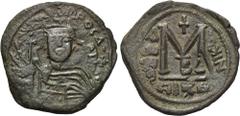 HERACLIUS ( 610-641). Follis. Nicomedia. Obv: Helmeted, draped and cuirassed bust facing, holding globus cruciger and shield. Rev: Large M between A/N/N/O and NIKO (date overstruck); above, cross; ben