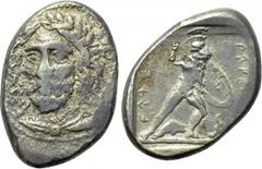 DYNASTS OF LYCIA. Perikles (Circa 380-360 BC). Stater. Antipellos. Obv: Laureate and draped bust facing slightly left. Rev: Warrior in fighting attitude right, holding sword and shield; below, dolphin
