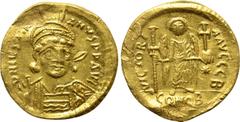 Byzantine Coins JUSTINIAN I (527-565). GOLD Solidus. Constantinople. Obv: D N IVSTINIANVS P P AVG. Helmeted and cuirassed bust facing slightly right, holding spear and shield decorated with horseman m
