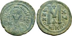Byzantine Coins JUSTINIAN I (527-565). Follis. Nicomedia. Dated RY 15 (541/2). Obv: D N IVSTINIANVS P P AVG. Helmeted and cuirassed bust facing, holding globus cruciger and shield decorated with horse