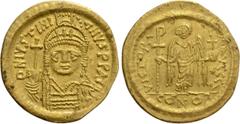 Byzantine Coins JUSTINIAN I (527-565). GOLD Solidus. Constantinople. Obv: D N IVSTINIANVS P P AVG. Helmeted and cuirassed bust facing, holding globus cruciger and shield decorated with horseman motif.