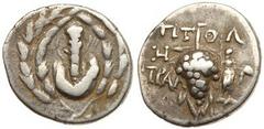 Lydia, Tralleis. Silver Cistophoric Didrachm (6.05 g), ca. 166-67 BC. Ca. 133-125 BC. Ptol., magistrate. Lion's skin draped over club; all within ivy wreath. Reverse: TPAΛ to left, grape bunch on vine