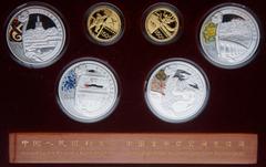 China. Gold and Silver Set for the Beijing Olympic Games, 2008. Gold 150 Yuan (2 pieces). 1/3 Ounce each .999 fine gold. Silver 10 Yuan (4 pieces) 1 ounce each. Gold features an ancient Chinese swimmi