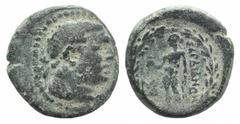 Lydia, Sardes, c. 133 BC-AD 14. Æ (16mm, 4.50g, 12h). Laureate head of youthful Herakles r., lion skin tied around neck. R/ Apollo standing l., holding crow and laurel branch; monogram to l.; all with