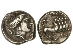 Tetradracma. 340-320 a.C. SICILIA. PANORMOS. Anv.: Busto femenino a derecha, rodeado de delfines. Rev.: Cuadriga galopando a derecha, encima Nike a izquierda, volando. 17,10 grs. AR. (Golpe en anverso