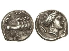 Tetradracma. 340-320 a.C. PANORMOS. SICILIA. Anv.: Cuadriga a derecha, Nike volando a izquierda, coronando al conductor del carro. Rev.: Cabeza femenina con corona de espigas a derecha, alrededor tres
