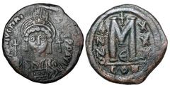BYZANTINE EMPIRE. Justinian I, 527-565 AD. Æ Follis (17.01 gm) of Constantinople, yr 30-E. Crowned bust facing / Large M. S.163. VF, dark brown patina. ex Khristov coll. [Est. $225]