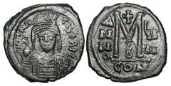 BYZANTINE EMPIRE. Maurice TIiberios, 582-602 AD. Æ Follis (11.51 gm ) of Constantinople, yr 9 B Helmeted bust facing / Large M. S.494. VF+, brown black patina. ex Khristnov collection. [Est. $250]
