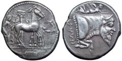 Sicily, Gela AR Tetradrachm. Circa 465-450 BC. Charioteer driving slow quadriga right, Ionic column behind, wreath before, ear of corn in exergue / Forepart of man-headed bull (river-god Gelas) with l