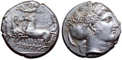 Sicily, Syracuse AR Tetradrachm. Second Democracy. Circa 415-405 BC. Charioteer, holding kentron in right hand and reins in both, driving fast quadriga left; Nike flying above right, crowning chariote