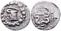 Lydia, Tralleis AR Cistophoric Tetradrachm. 133-126 BC. Serpent emerging from cista mystica; all within wreath / Bow-case with two coiled serpents; [TP]AΛ in left field, ΠΤΟΛ and E above, Dionysos wit