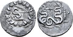 Greek Lydia, Tralleis AR Cistophoric Tetradrachm. Ptol-, magistrate. Circa 133-126 BC. Serpent emerging from cista mystica; the whole within wreath / Two serpents entwined around bow and bowcase; ΠTOΛ