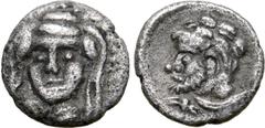 Greek Cilicia, uncertain mint AR Hemiobol. 4th century BC. Veiled and draped bust of female facing slightly to left, wearing earrings and necklace / Bearded head of Herakles to left, with lion skin ti