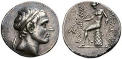 COINS OF THE GREEK WORLD SELEUCID KINGDOM Antiochus III, 223-187. Tetradrachm from 197, uncertain mint in Mesopotamia. Diademed head to r. Rev. BAΣIΛEΩΣ / ANTIOXOΥ Apollo seated to l. on omphalos, hol